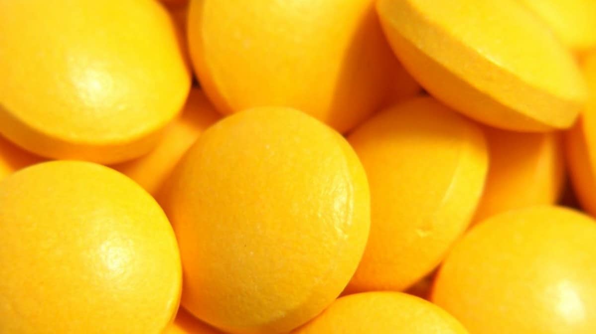 A bunch of round, yellow pills