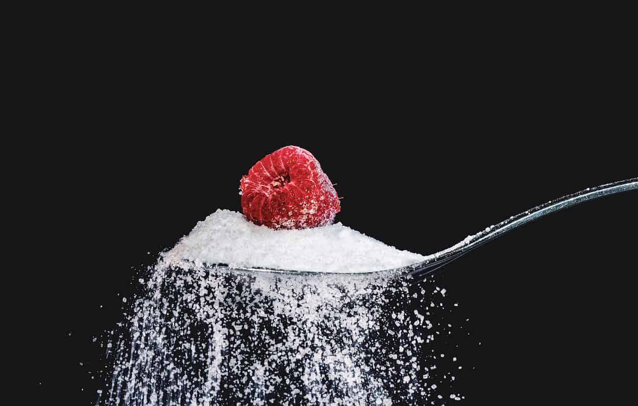 Sugar falling from the spoon.